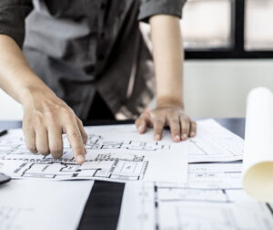 someone pointing to blueprint plans.